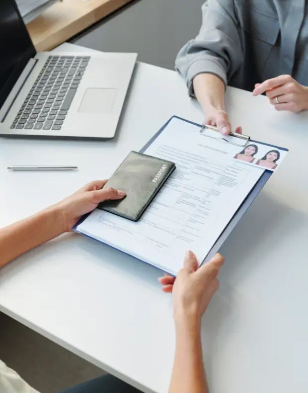 New American Hope LLC consultant reviewing EB-2 Employment-Based Visa documents with a professional client